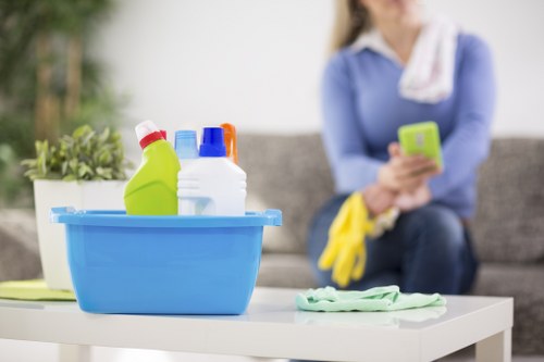 Cleaner wearing PPE while carrying out carpet cleaning work