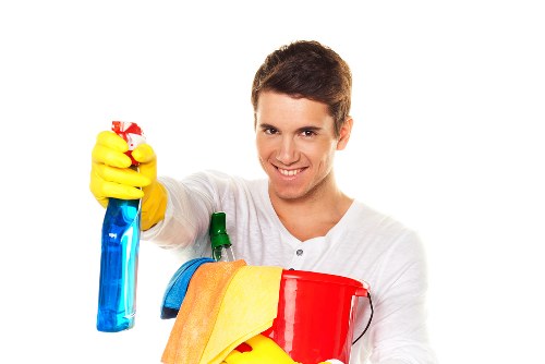 Technician finishing a carpet cleaning job with safety checks